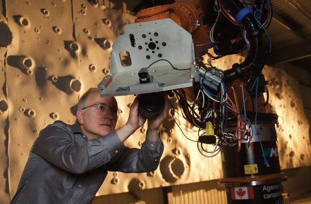 A scientist manipulating equipment