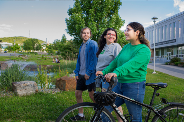 Étudiants sur le campus avec un vélo